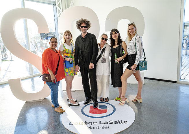Six individuals pose smiling at a Collège LaSalle event in Montréal, with a large '500' sign and college emblem.
