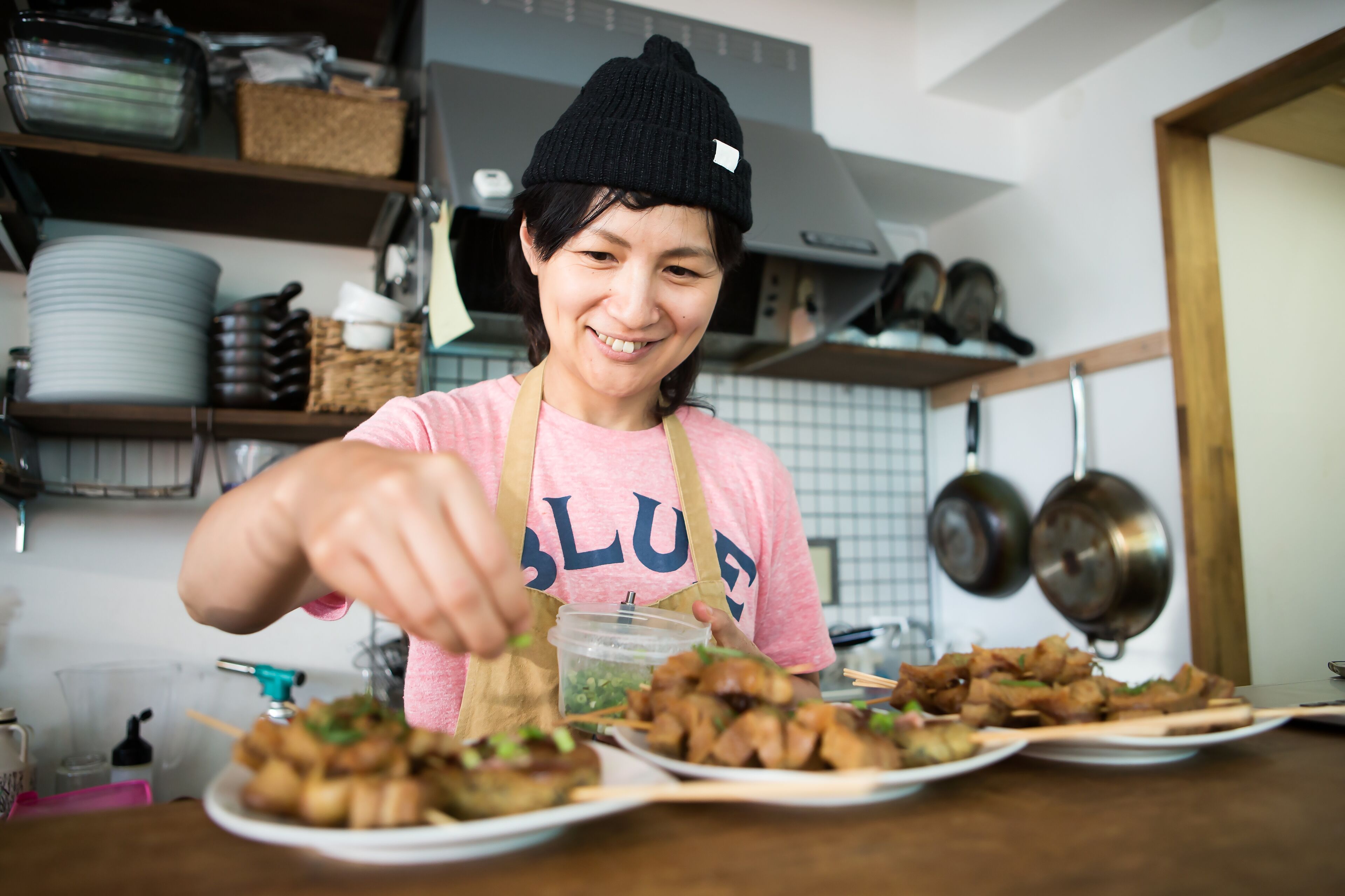 Woman Garnishing Food in Kitchen