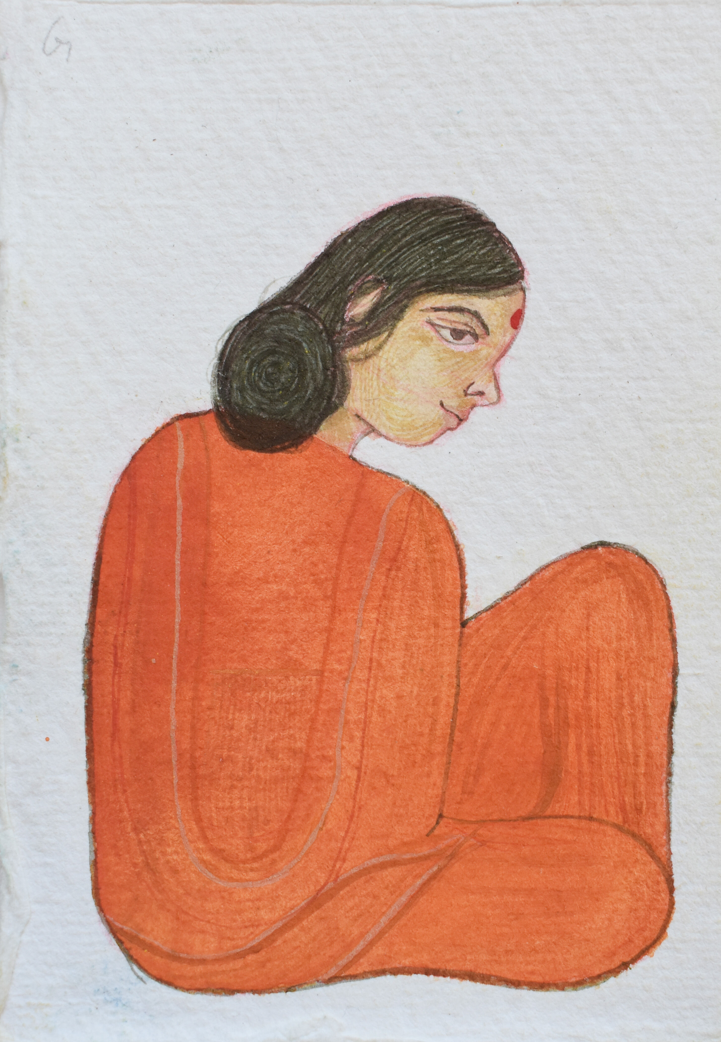 A side profile of a serene woman clad in an orange robe, with a traditional red bindi on her forehead, evoking a sense of calm contemplation.