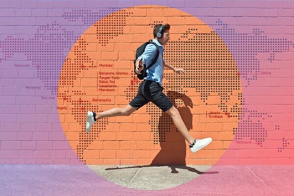 A man in motion, sprinting past a vibrant brick wall with a global city map.